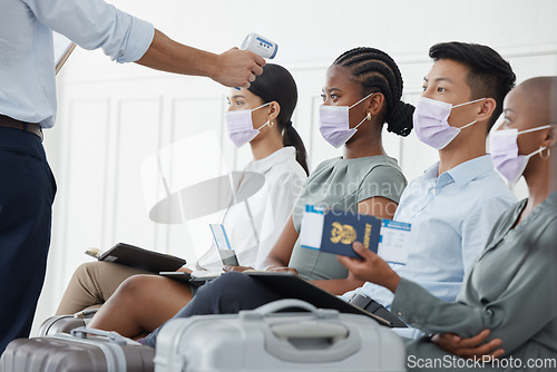 Image of Covid, travel and business people at the airport with thermometer doing temperature checks. Safety, testing and travelling for business during covid 19 pandemic with healthcare worker doing screening