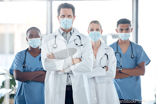 Image of Doctor, nurse and leadership, covid with face mask for team safety with arms crossed in a medical hospital. Proud, professional and motivated healthcare workers fight covid at clinic together