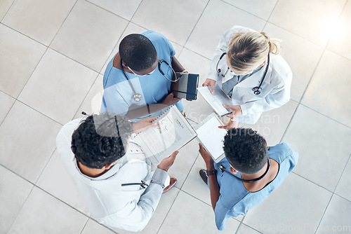 Image of Doctor documents, nurse data and hospital information of a healthcare medical team in a clinic. Teamwork and collaboration above view of nursing and health staff with paper and digital results