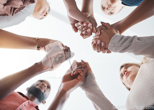 Image of Community, holding hands or psychology support diversity in mental health workshop, mind or therapy. Zoom on low angle men, women or people in friends trust circle in hope, motivation or anxiety help