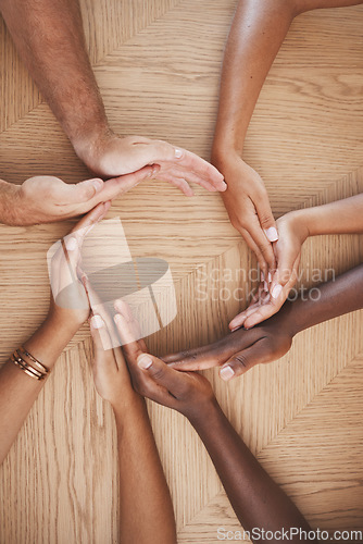 Image of Diversity, teamwork and creative hands in synergy of employee workers together in collaboration at work. Table group of people hand in circle unity for agreement, help and team for community