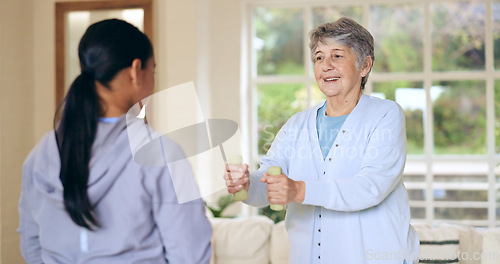 Image of Dumbbell weights, physiotherapy and an old woman with a caregiver in a nursing home for training. Health, fitness or exercise with a senior patient and nurse in a living room for physical therapy