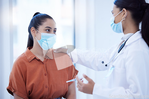 Image of Covid, vaccine and doctor calm woman during health consultation for immunity injection for protection against disease. Mask, healthcare and syringe, medical worker help comfort scared patient.