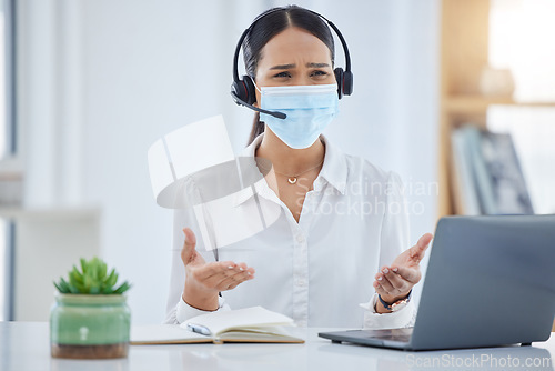 Image of Covid, call center and worker confused while consulting on the internet with a laptop in an office at work. Angry and frustrated customer service agent working in telemarketing with pc and face mask