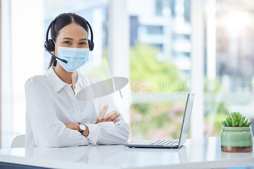 Image of Covid, compliance and healthcare consultant in a call center with ready to help medical clients with insurance. Woman, employee and contact support worker in safety face mask with headset and mic