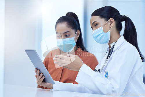 Image of Covid, consulting and patient, doctor and tablet with results, diagnosis and online medical report. Healthcare, covid 19 and women in doctors office with face mask, digital tech and analysis