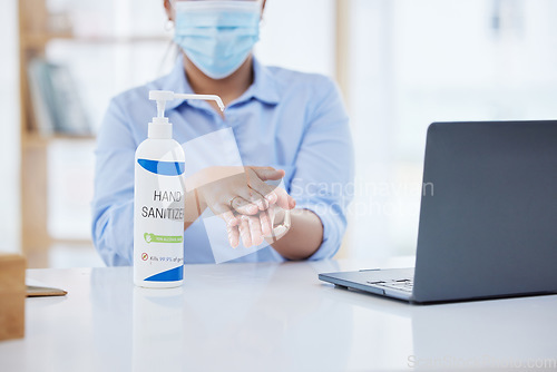 Image of Covid, business woman at desk and hand sanitizer for hygiene and safety, protection against virus. Cleaning, laptop and health compliance of corporate, medical policy and clean working environment.