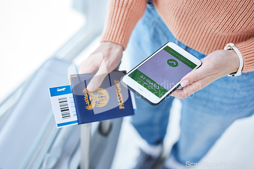 Image of Phone, covid passport and qr code in the hands of a woman passenger in the airport for immigration, travel or control. Security, app and mobile with a female traveler holding her identity documents