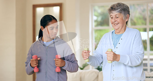 Image of Dumbbell weights, physiotherapy and an old woman with a caregiver in a nursing home for training. Health, fitness or exercise with a senior patient and person in a living room for physical therapy