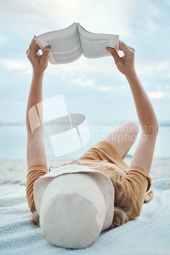 Image of Book, beach and woman reading on holiday for calm, peace and travel by the ocean in Bali during summer. Free, relax and girl with novel on the tropical sand while on an island vacation in nature