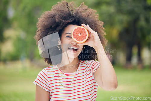 Image of Woman, happy and diet with grapefruit for healthy detox and face in a nature park in summer. Portrait of female vitamin c skincare and wellness with beauty keeps her fresh, wellness outdoor in summer