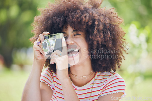 Image of Photographer, happy and woman with a camera in nature enjoying taking pictures of a natural environment. Smile, happiness and Afro girl outdoors shooting creative shots as a freelancer in photography