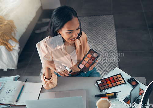 Image of Female lifestyle, makeup vlogger recording a tutorial on phone for social media. Top view of beauty influencer testing eyeshadow palette colors or cosmetics on a live streaming video to share online