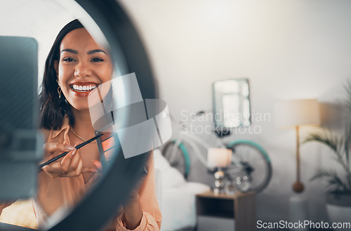 Image of Beauty influencer, vlogger or podcast host talking with a phone to film live stream makeup tutorial with eyeshadow makeup palette. Excited woman using technology to promote a cosmetic product online