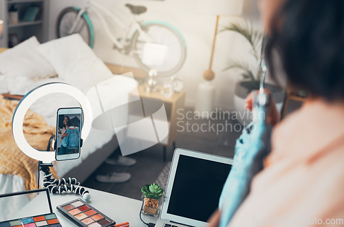 Image of Fashion influencer, style vlogger or social media entrepreneur live streaming content online with her phone. Trendy freelancer recording or posting a video to her channel for viewers and subscribers