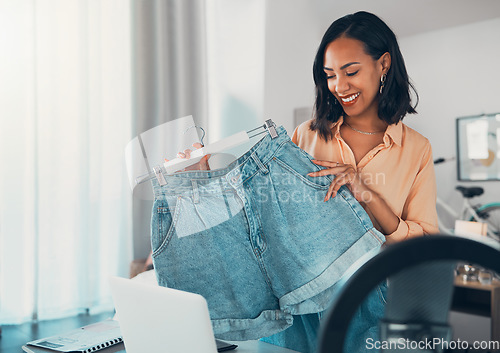 Image of Fashion influencer, style and design with a creative and trendy female holding denim shorts in her small business and startup vlog. Fashionable, stylish and modern clothing for a social media blog