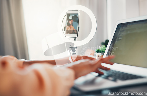 Image of Social media influencer, content creator and vlogger typing online blog on her laptop about lifestyle and glamour. Entrepreneur, freelancer and creative woman recording herself working as a blogger