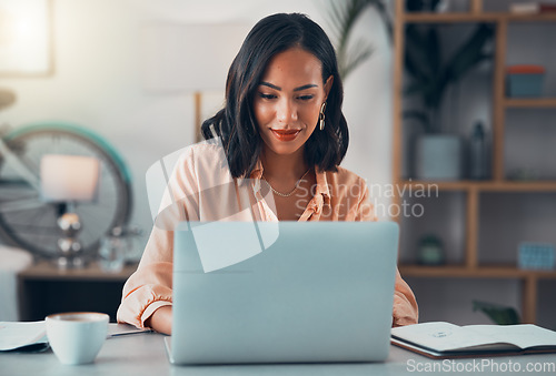 Image of Woman working on laptop online, checking emails and planning on the internet while sitting in an office alone at work. Business woman, corporate professional or manager searching the internet