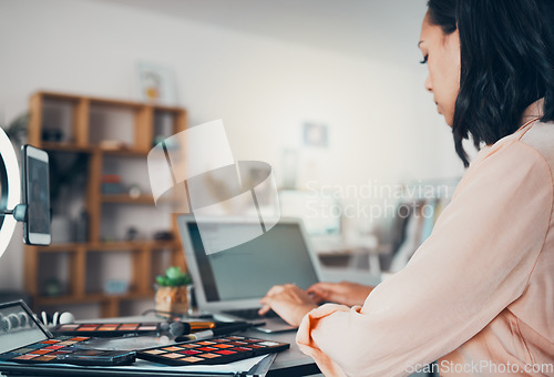 Image of Beauty blogger, freelancer and entrepreneur working on laptop, writing notes, product reviews and makeup brand marketing while working from home. Busy female influencer checking emails and networking