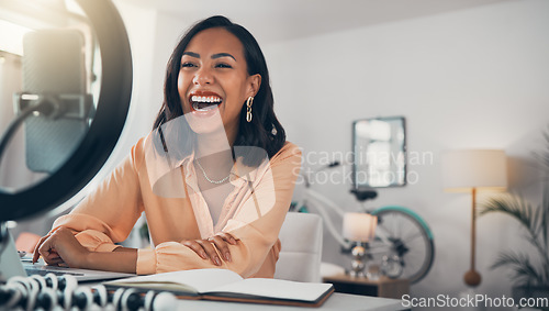 Image of Social media and business influencer streaming live tutorial, laughing and talking to her online followers. Guiding subscribers on finance, investment, banking and accounting while enjoying her blog