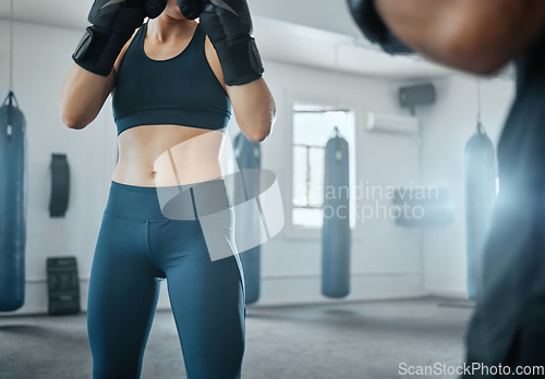 Image of Female fitness boxing with trainer, learning self defense with coach at gym and training for wellness at a sports center with an instructor. Man teaching an athletic woman to fight and do cardio