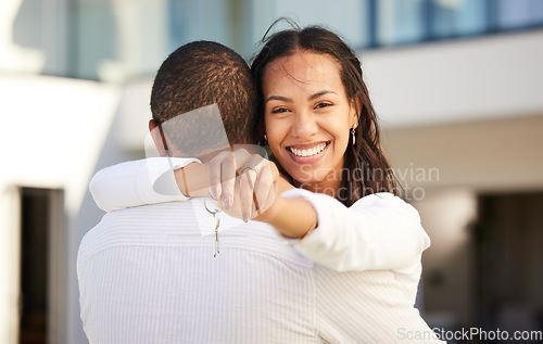 Image of Happy couple moving with keys of house, property and real estate with a hug and smile after purchase, rent or buy new home or apartment. Man and woman or homeowners relocate together with joy