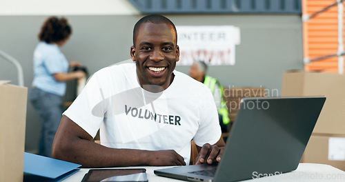 Image of Volunteer man, laptop and portrait for donation, clothes drive and smile for community service, scroll and web. African person, pc and social responsibility with boxes, charity and ideas for helping