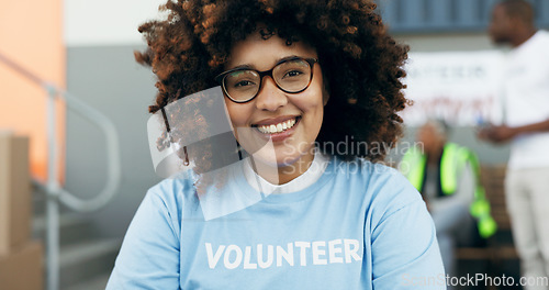 Image of Volunteer woman, portrait and happy for charity, clothes drive and community service with kindness at desk. African girl, ngo and social responsibility with donation boxes, care or smile for helping