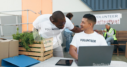 Image of Team, volunteer and laptop for donation, charity and outreach program by people outdoor. Tech, collaboration and men in nonprofit, support and social responsibility, community service and NGO