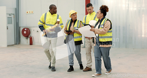 Image of Construction site, blueprint and business people walking in a building planning, discussion or renovation idea. Architecture, project management and engineer team in warehouse for design conversation