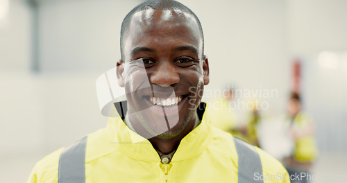 Image of Smile, happy and portrait of black man construction worker standing with confidence in a warehouse. Positive, pride and young African industrial employee at an indoor site for maintenance or repairs.