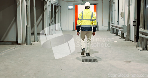 Image of Warehouse, back of man and engineer walking at empty industrial plant, manufacturing production or construction. Factory, rear view and worker or technician check storage, distribution and logistics
