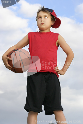 Image of Standing child holding a basketball