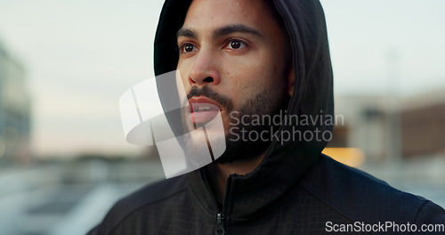 Image of Fitness, breathing and thinking, man in city on rest from morning wellness workout in hoodie. Relax, face and tired athlete on calm urban exercise with fatigue, reflection and outdoor air on street.