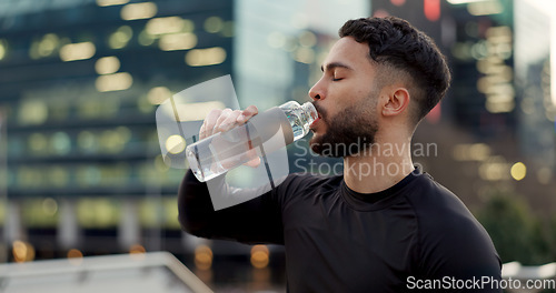 Image of Man, drinking water and fitness in city after workout, exercise or outdoor training for natural sustainability. Thirsty male person with mineral drink in rest, recovery or break for hydration in town