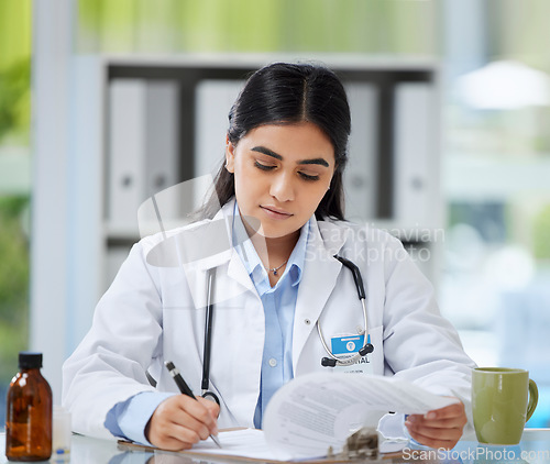 Image of Doctor, healthcare worker and gp reading, writing and planning test results, patient record and medical research in a hospital or medical clinic. Organized healthcare expert working on treatment plan