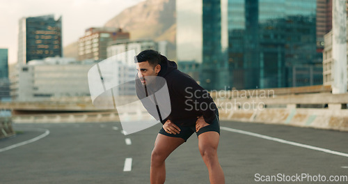 Image of Man, athlete and breathe in road for fitness, exercise or wellness with city background or nature. Runner, person and break or tired for workout, training and healthy body with sportswear in street