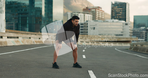 Image of Man, athlete and breathe in road for fitness, exercise or wellness with city background or nature. Runner, person and relax or tired for workout, training and healthy body with sportswear in street