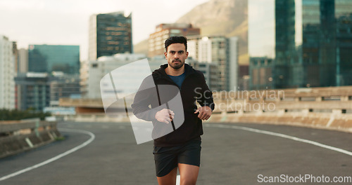 Image of Man, morning and running in city street, road and bridge for fitness, workout and marathon training. Athlete, person or exercise in South Africa for cardio wellness, health or triathlon performance