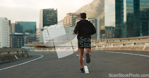 Image of Sports, back and running in morning on city, street and bridge for fitness, workout and marathon training. Athlete, man or exercise on South Africa road for wellness, health or triathlon performance