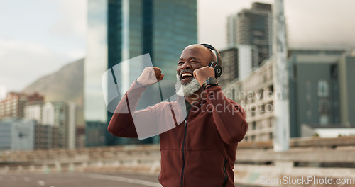 Image of Fitness, excited and senior man, headphones, city and achievement with workout, streaming music and radio. African person, pensioner and runner with headset, progress and exercise wellness or outdoor