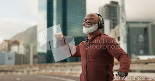 Image of Fitness, celebration and senior man, headphones, city and achievement with workout, streaming music and radio. African person, pensioner and runner with headset, progress and exercise wellness or joy