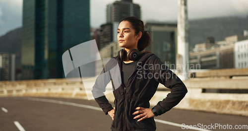 Image of Thinking, city and woman training, active and looking at view, buildings and planning morning cardio, wellness or workout. Sunshine, road or fitness athlete, runner or person exercise in Chicago, USA