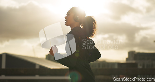 Image of Woman, morning and running in city with headphones for fitness, workout and marathon training music. Sun lens flare, athlete or exercise podcast in Brazil for cardio wellness, health or sports radio