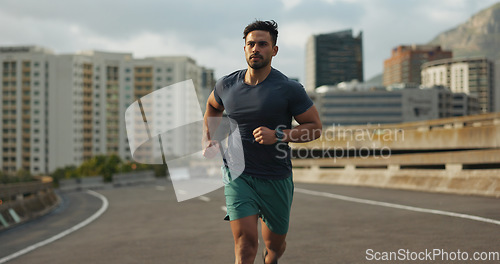 Image of Running, city and man on road in training, endurance and fitness lifestyle for marathon competition. Indian runner, exercise commitment and body wellness for cape town race, progress and urban sport