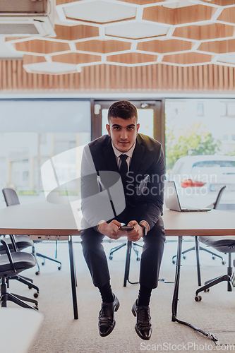 Image of A businessman sitting on his desk, taking a moment to rest and unwind from a demanding workday, displaying a sense of tranquility and relaxation amidst the corporate environment