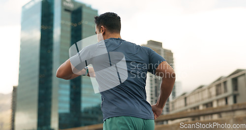 Image of Running, city or man with time in training, practice or fitness goals for marathon competition. Young athlete, wellness or speed runner for france race with progress, urban road or health lifestyle