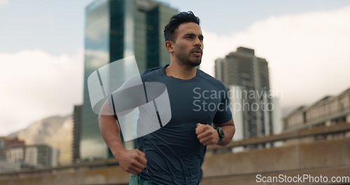 Image of Exercise, running and a sports man in the city for cardio training to improve fitness for a marathon. Wellness, workout or health with a young runner or athlete in an urban town for a speed challenge