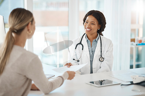 Image of Doctor and patient discuss paperwork during medical consultation in a hospital. Healthcare professional, GP or physician prepare insurance document and checking personal information at a clinic