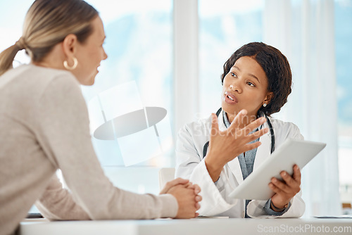 Image of Female doctor browsing a tablet and giving medical advice to a woman. Surgeon, physician or GP showing patient scan results while explaining, consulting and advising surgery procedure at a hospital